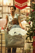 Thembi Mbengashe, ex-Miss SA finalist and former SABC 1 continuity announcer, pushes an unidentified child in a trolley while Christmas shopping in Sandton City. \nPic: Simon Mathebula. 20/12/2002.  © Sunday Times.\n\nPLEASE BE PATIENT: Consumer spending will pick up next year and although the easing of interest rates should provide some relief for consumers, it could take up to six months before they feel the benefits. Business Day Weekender, 20/12/2008, page 2.