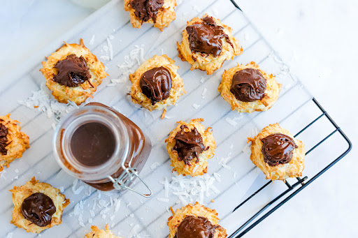 Ganache Filled Coconut Macaroons on a cooling rack.