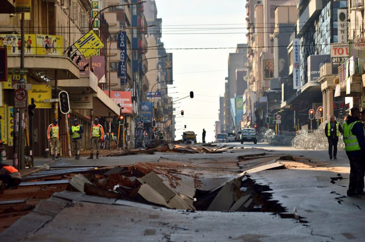 The explosion in the CBD saw a busy street cave in, with several vehicles flung off the road or toppled by the force of the blast.