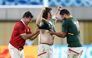 South Africa's Schalk Brits (L) and Malcolm Marx (R) exchange a match jersey with a Canadian player after the match. 