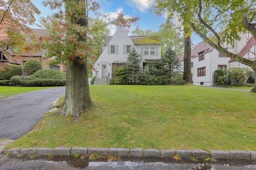 White house with green lawn in this luxury property for rent in Scarsdale ($8,000)