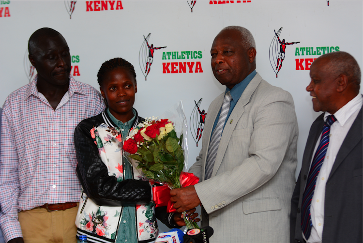 AK president Jack Tuwei and vice president Paul Mutwii receive world marathon record holder Brigid Kosgei and her coach Erick Kimaiyo at Riadha House on October 16