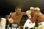 Lovemore Ndou, left, pummels  challenger Bongani 'Cyclone' Mwelase at Emperor's Palace in 2010.   