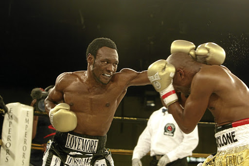 Lovemore Ndou, left, pummels challenger Bongani 'Cyclone' Mwelase at Emperor's Palace in 2010. / Antonio Muchave