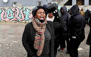 Community members of Philippi in the Western Cape march this year to a police station during a protest against gender-based violence. Seen here is activist Yonda Gebenga wearing a boxing glove.