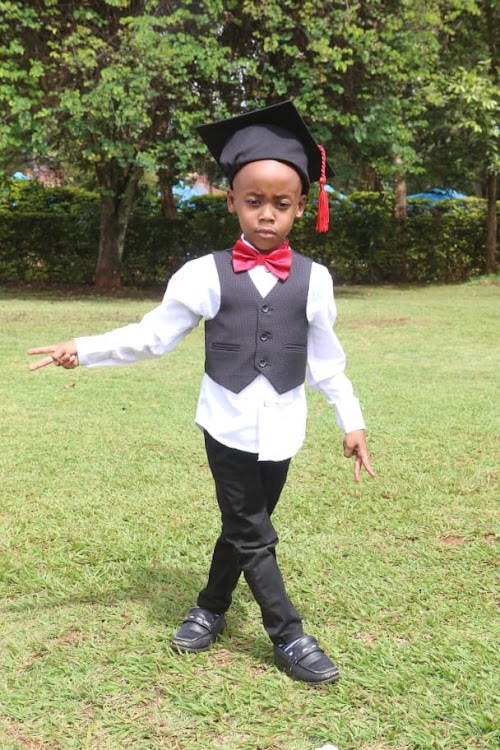 isaac mwauras son poses for graduation pic