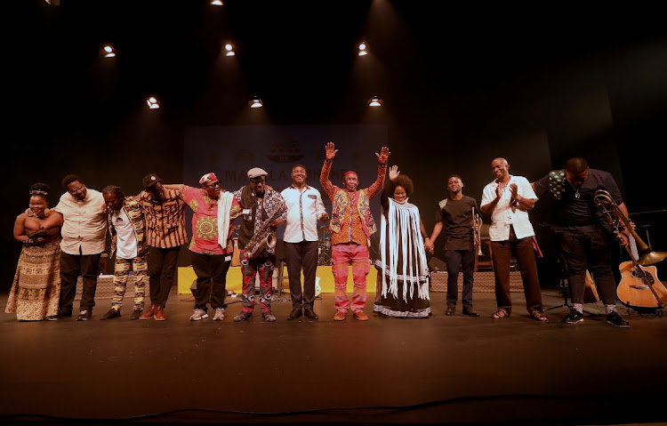 Legendary jazz musician Dr Madala Kunene raises his hands as he and the team of artists bid good night to fans after performing at Playhouse in Durban.