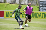 Itumeleng Khune perfects his kicking skills while Dino Ndlovu watches on during yesterday's  session at Steyn City.  /Lefty Shivambu/ Gallo Images