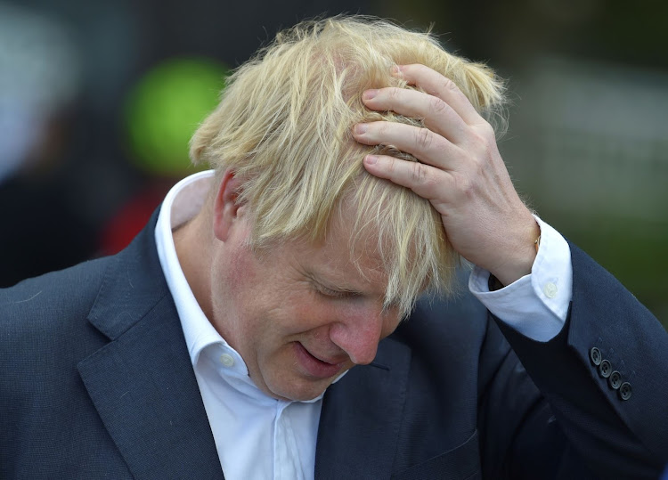 Britain's Prime Minister Boris Johnson reacts as he speaks to local cyclists at the Canal Side Heritage Centre, after the government announced a new plan to get Britain cycling, amid the outbreak of the coronavirus disease (COVID-19), in Beeston near Nottingham, Britain, July 28, 2020. Rui Vieira/Pool via REUTERS