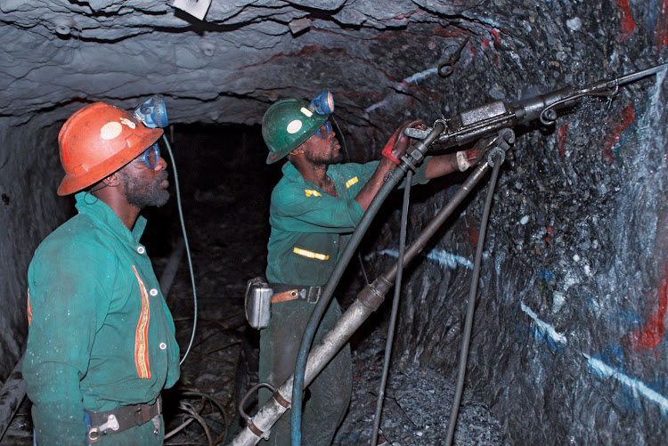 Miners drilling for gold in a goldmine