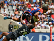 Aphelele Fassi of the Cell C Sharks tackles Courtnall Skosan of the Emirates Lions during the Super Rugby #SuperHeroSunday match at Cape Town Stadium on February 03, 2019.   