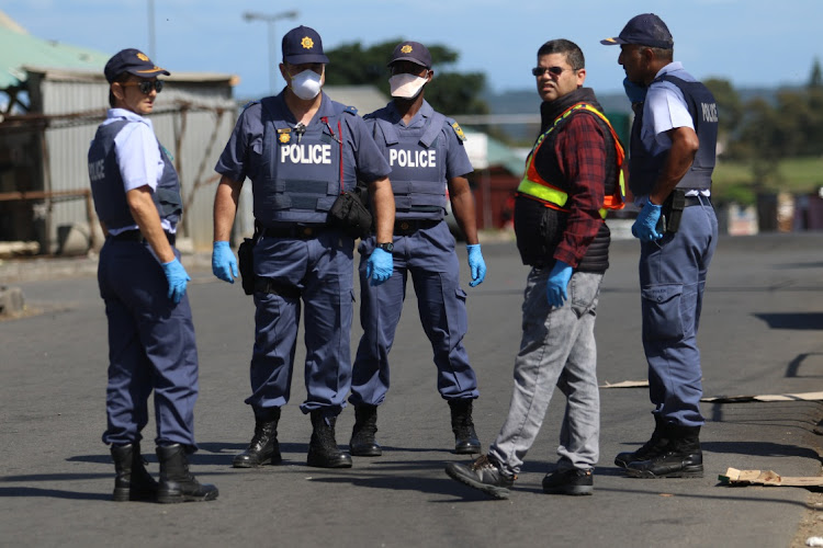 Police officers at Mdantsane Highway taxi rank.