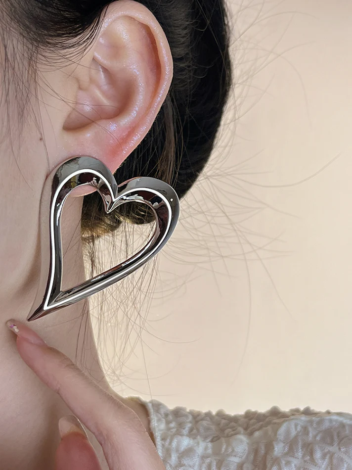 Boucles d'oreilles cœur creux en métal, design accrocheur pour l'été, style européen et américain, parfaites pour un look estival unique et tendance.