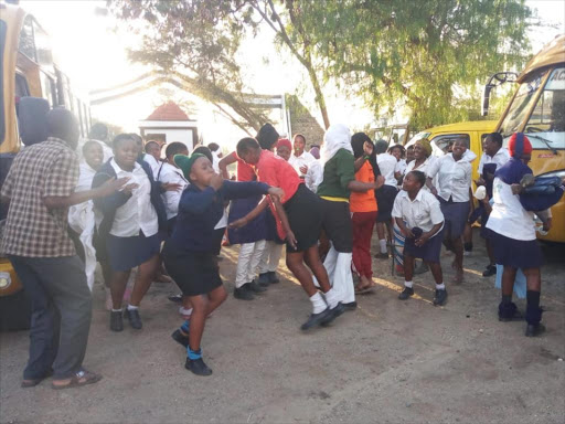 Teachers and KCSE candidates break into song and dance at Star Sheikh Primary School in Athi River, Machakos County on Monday following good results/ GEORGE OWITI