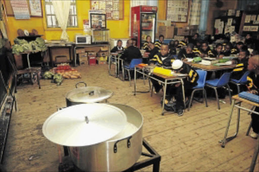 WHAT'S COOKING: Pupils go about their class work while their lunch, a pot of samp, boils on a gas stove at Volksrust Primary School