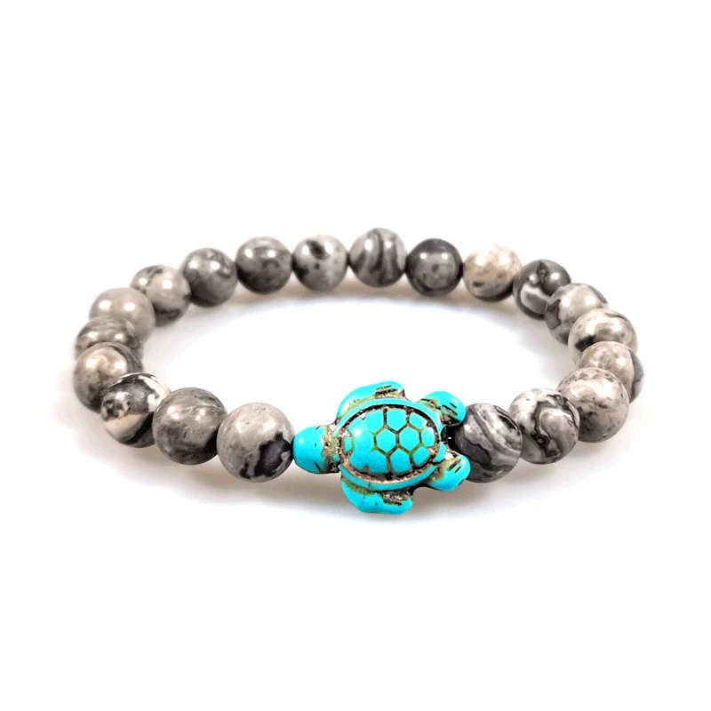 Bracelet couple avec tortue et pierres élastiques, un bijou tendance et symbolique pour célébrer l'amour et l'engagement mutuel.