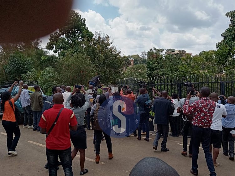 A plain cloth police officer jumps on the fence at Cleophas Malala’s home. HILTON OTENYO