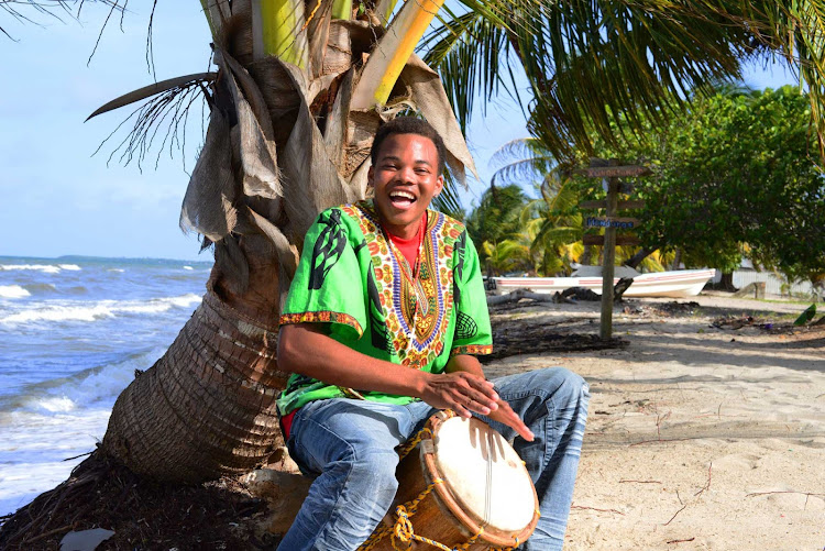 Drum playing on a beach in Belize.