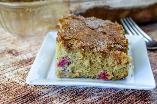 Rhubarb Cake slice on a plate.