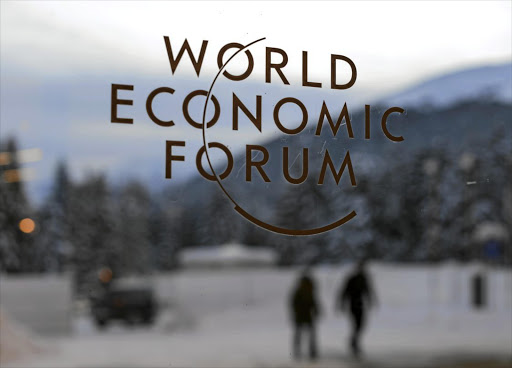 The logo of the World Economic Forum on a window pane at the Congress Centre. The forum's annual meeting in Davos, Switzerland, starts on Tuesday.