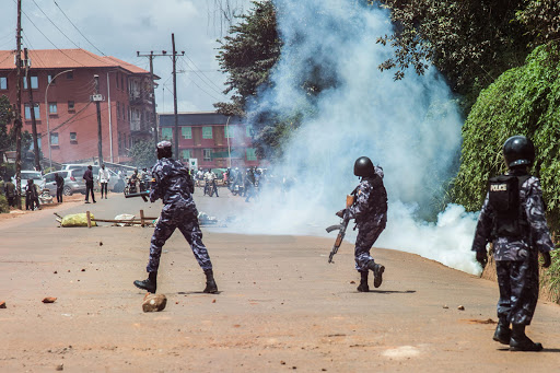 Uganda police officers conftont students of Makerere university during their protest against the 15 percent tuition increment in Kampala, Uganda, on October 30, 2019. (Photo by Isaac Kasamani / AFP) (Photo by ISAAC KASAMANI/AFP via Getty Images)