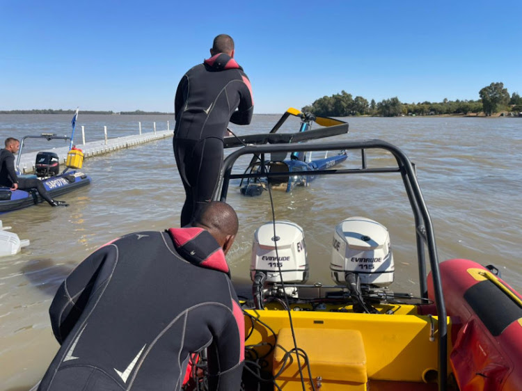 National Sea Rescue Institute members help recover the wrecked Robinson R44 helicopter from Vaal Dam.