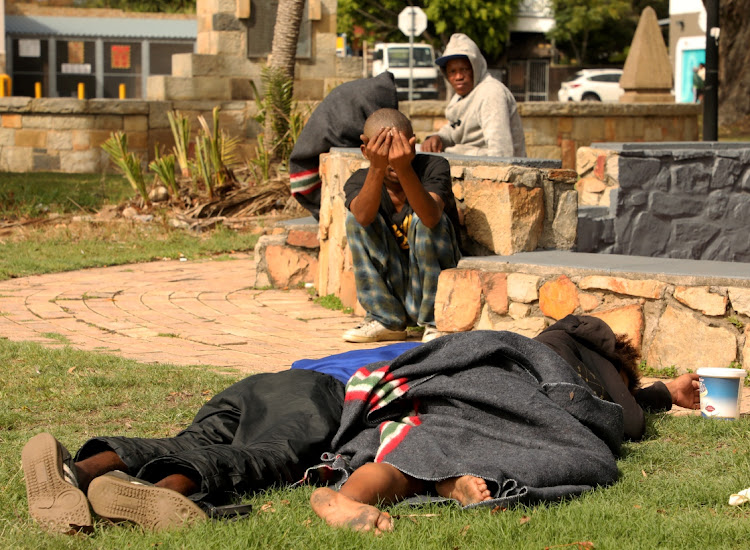 WE ARE HOMELESS, HOMELESS: People from the streets sleep in the sun outside the Walmer Town Hall, their home during the lockdown to help contain the spread of the coronavirus