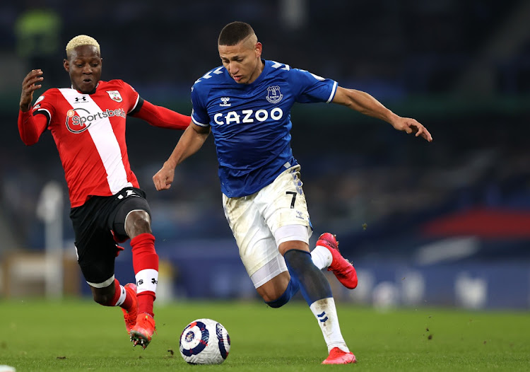 Richarlison of Everton battles for possession with Moussa Djenepo of Southampton during the Premier League at Goodison Park in Liverpool on March 1, 2021