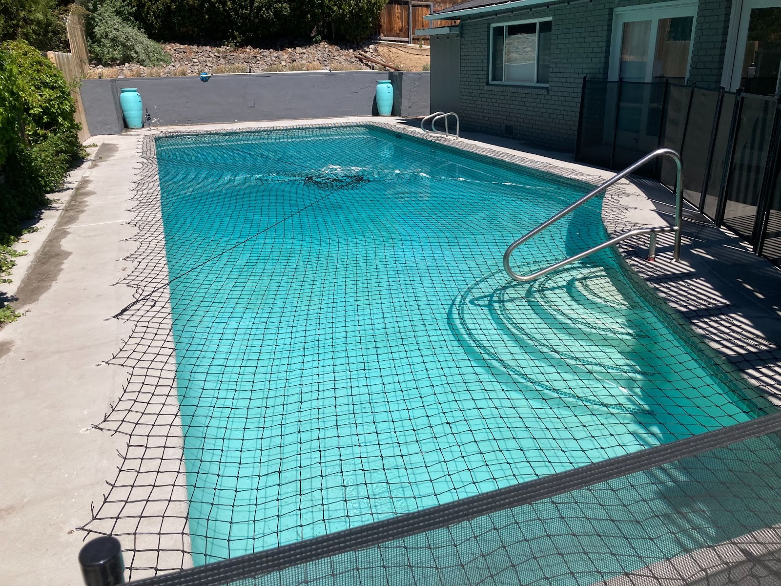 Black swimming pool net installed on a pool