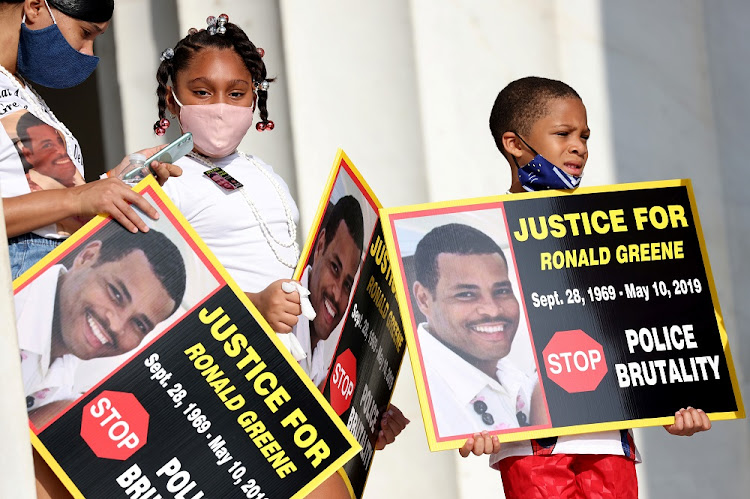 Family members of Ronald Greene listen to speakers as they gather at the Lincoln Memorial during the 'Get Your Knee Off Our Necks' march in support of racial justice in Washington, US, on August 28 2020.
