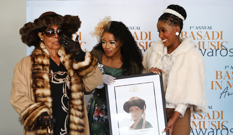 Legendary singer Abigail Kubeka receives a framed sketch from the CEO and founder of Basadi in Music Awards Hloni Modise and Johannesburg mayor Dr Mpho Phalatse at the Garden Venue during the inaugural Basadi In Music Awards CEO's Legends Luncheon.