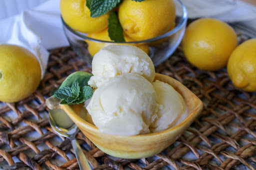 Three scoops of yummy lemon custard ice cream in a bowl.