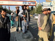 A member of the Taliban stands outside Hamid Karzai International Airport in Kabul on August 16 2021. The SA government says it has made contact with South Africans stranded in Afghanistan after Taliban forces took over the country on Sunday. 