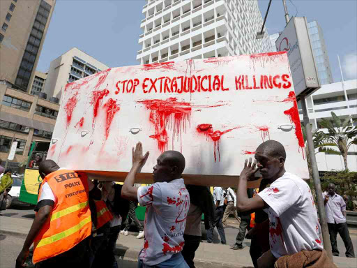 Members of the civil society carry a coffin stained with mock blood as they chant slogans during a protest in Nairobi dubbed 'Stop extrajudicial killings', on the killing of human rights lawyer Willie Kimani, his client and their driver, July 4, 2016. /REUTERS