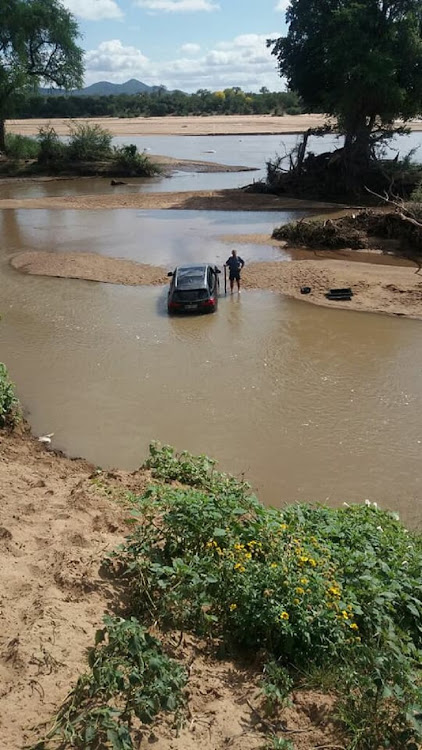 Police prevent stolen cars crossing river at border into Zimbabwe.