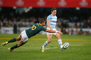 Argentina's Nicolas Sanchez kicks under pressure from South Africa's Handre Pollard during the Rugby Championship match at Kings Park Stadium in Durban on August 18, 2018.