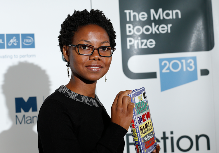 Man Booker prize shortlist nominee Noviolet Bulawayo poses with her book "We Need New Names" at the Southbank Centre in London, on October 13, 2013.