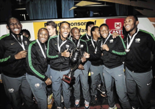 THE SMILES SAY IT ALL: The South African under-20 national team players arrive at OR Tambo International Airport in Johannesburg yesterday. Amajita were returning from Russia where they won the Commonwealth Cup on Sunday Photo: Lefty Shivambu/Gallo Images