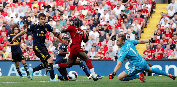 Liverpool's Sadio mane in action with Arsenal's Sokratis Papastathopoulos and Bernd Leno