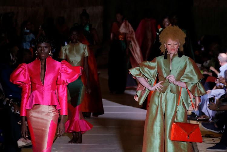 Models present creations by Al Gueye designer during the 19th annual Dakar Fashion Week.