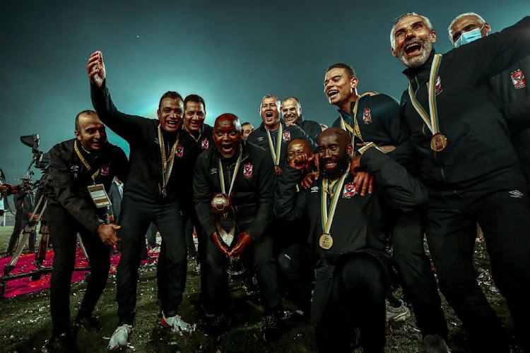 Pitso Mosimane (with trophy) and Al Ahly, including South African members of his technical staff Kabelo Rangoaga (fitness trainer, front right) and assistant-coach Cavin Johnson (back centre) celebrate winning the Caf Champions League title with Friday night's 2-1 final victory against Zamalek at Cairo International Stadium.