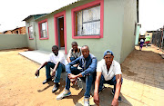 LAY FOUNDATIONS  Parolees Mpho Dikgale, Thabo Makoala, Richmond Tau and Kabelo Mhlongo beam with pride outside the  house they helped rebuild for a Soweto family after it was gutted  by a fire 