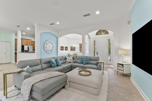 Modern living room with grey sectional sofa in this luxury property for sale in Fernandina Beach ($615,000)
