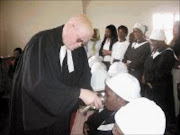 BREAKING BREAD: The Reverend Thembinkosi Zefried Mkhize of the Evangelical Lutheran Church of Southern Africa administered holy communion to members of his congregation in Daveyton, Ekurhuleni yesterday. Pic. Dan Fuphe. 03/02/2008. © Sowetan.