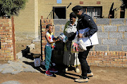 Thoko Doyi and her granddaughter Thuli were among the first in line to inquire about  African Children’s Feeding Scheme food parcels.