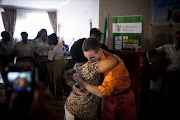 A survivor of the 1996 bomb blast in Worcester hugs one of the bombers, Stefaans Coetzee at the Pretoria Central Prison on January 31, 2013 in Pretoria. Coetzee was one of the AWB members who bombed a Shoprite in 1996 which killed four people.