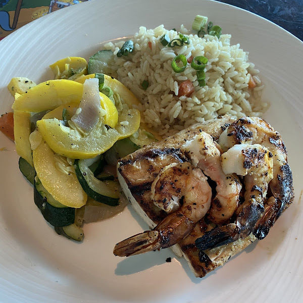 Mahi Mahi with Shrimp, rice and vegetables. So delicious and celiac safe! Just let them know when you order.