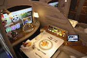 A meal lies served in a compartment in first class on board an Emirates A380 passenger plane at the ILA 2016 Berlin Air Show.