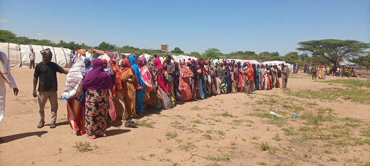 IDPs from Bakuyu and Mororo line up to receive both food and non food items.