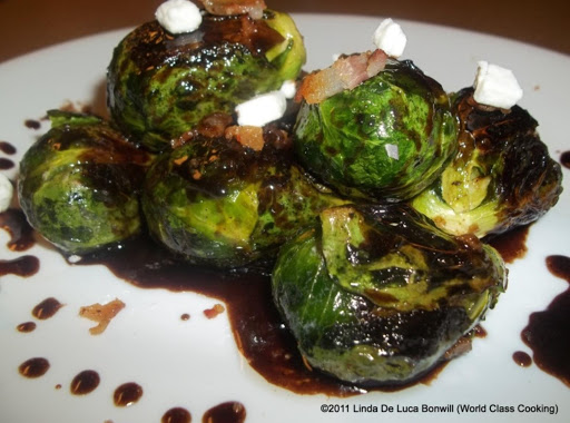 Grilled Brussel Sprouts sprinkled with bacon, goat cheese and balsamic reduction.